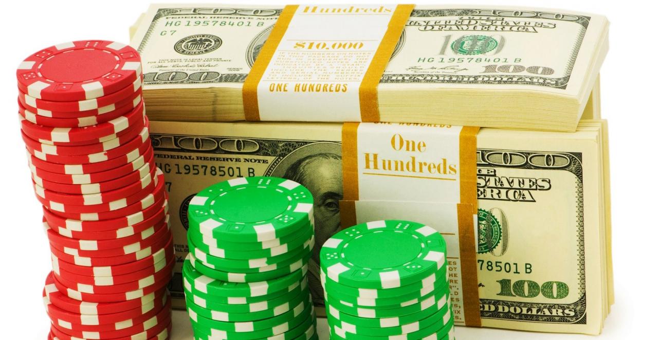 Casino bonus chips staked in front of a stack of dollar bills